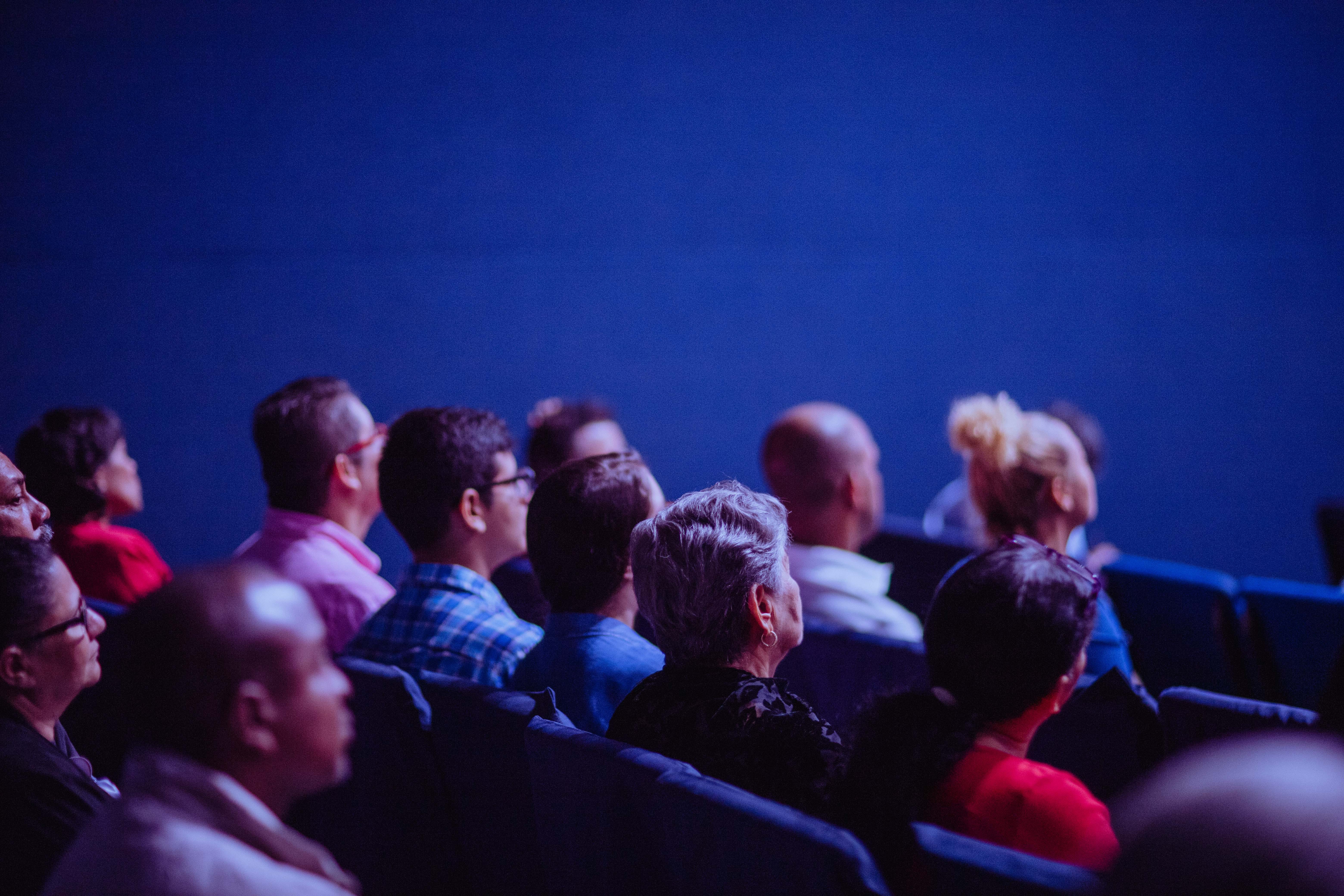 Photo showing people sitting watching a presentation.