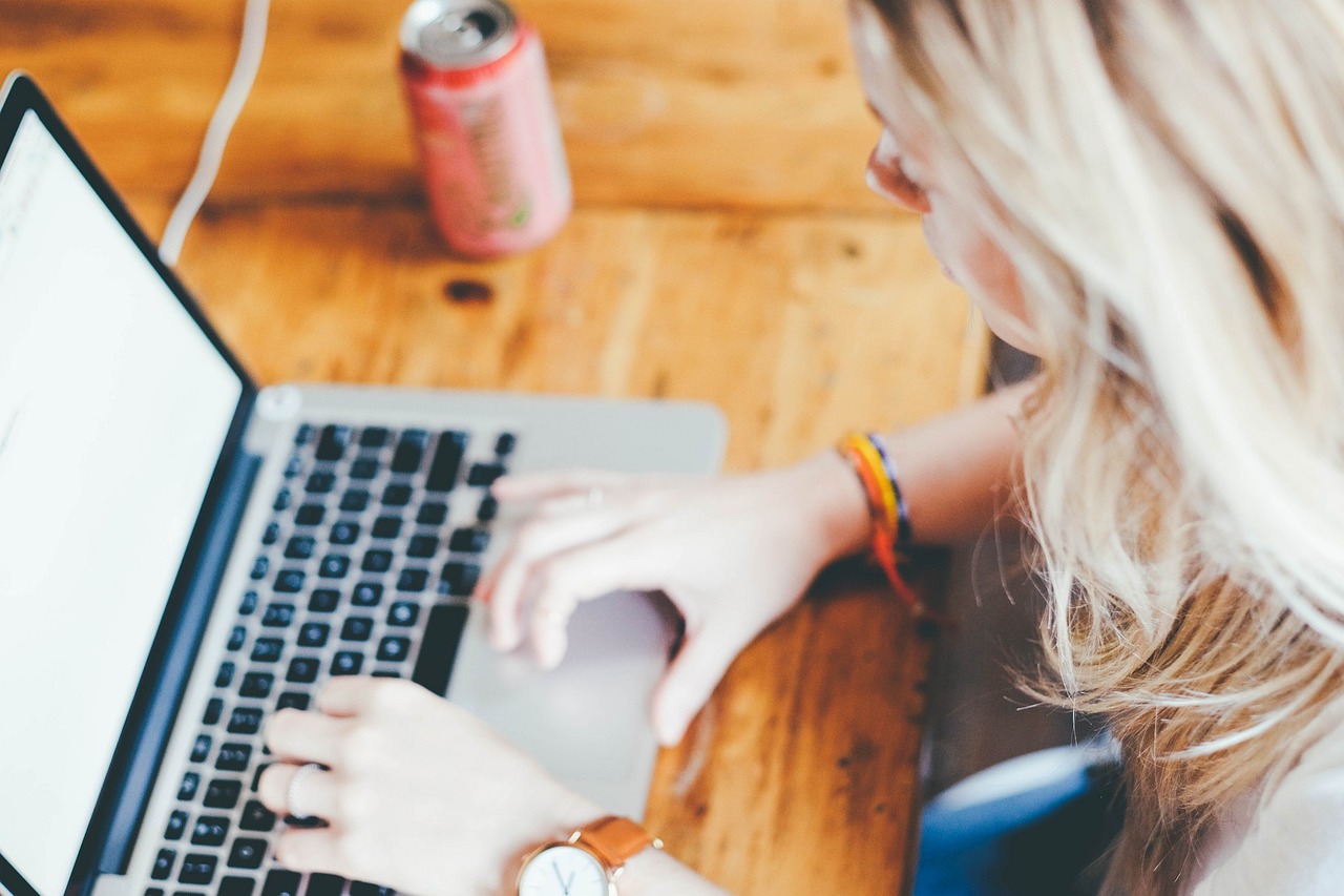 A woman uses a laptop at home.