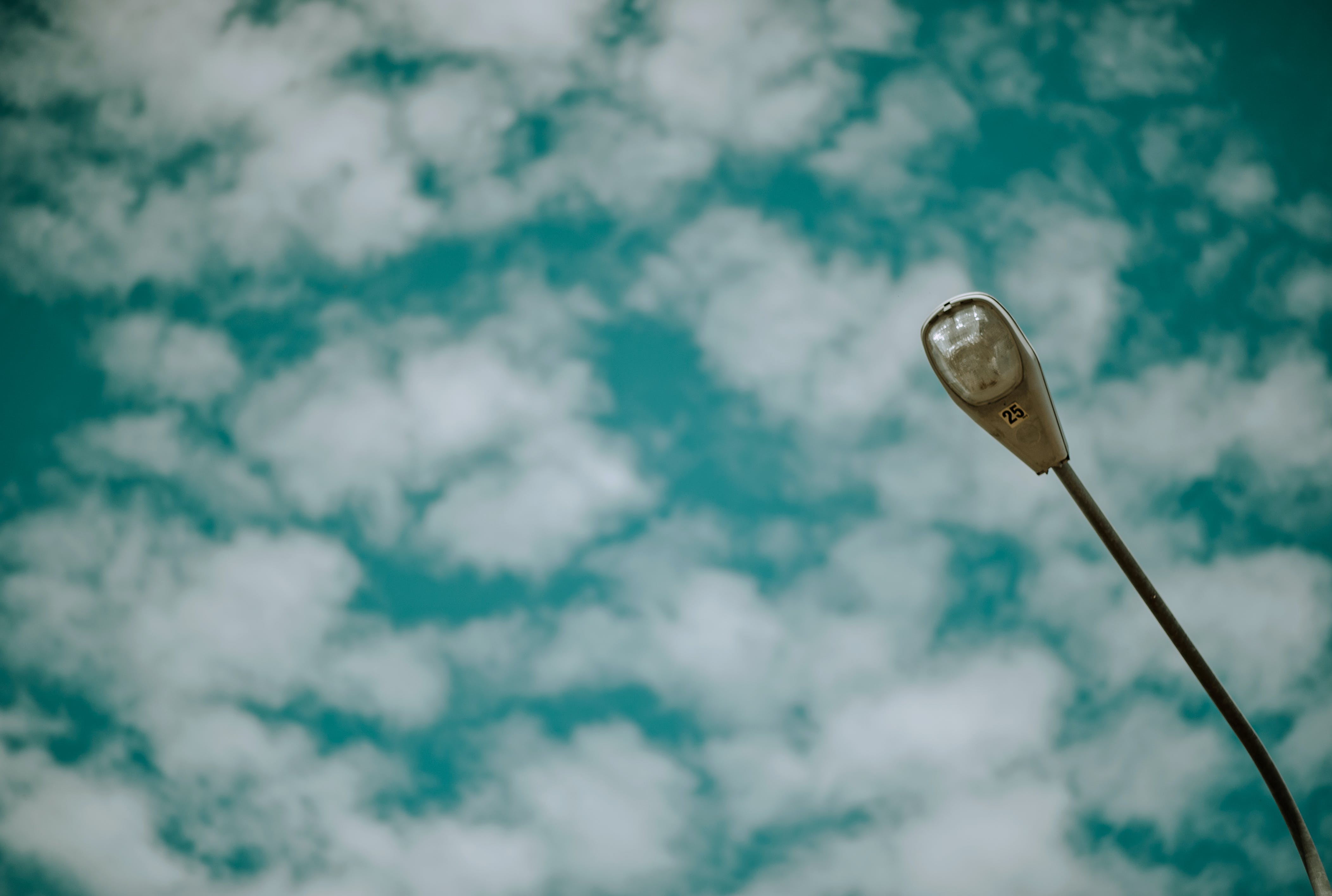 A street light under cloudy skies.