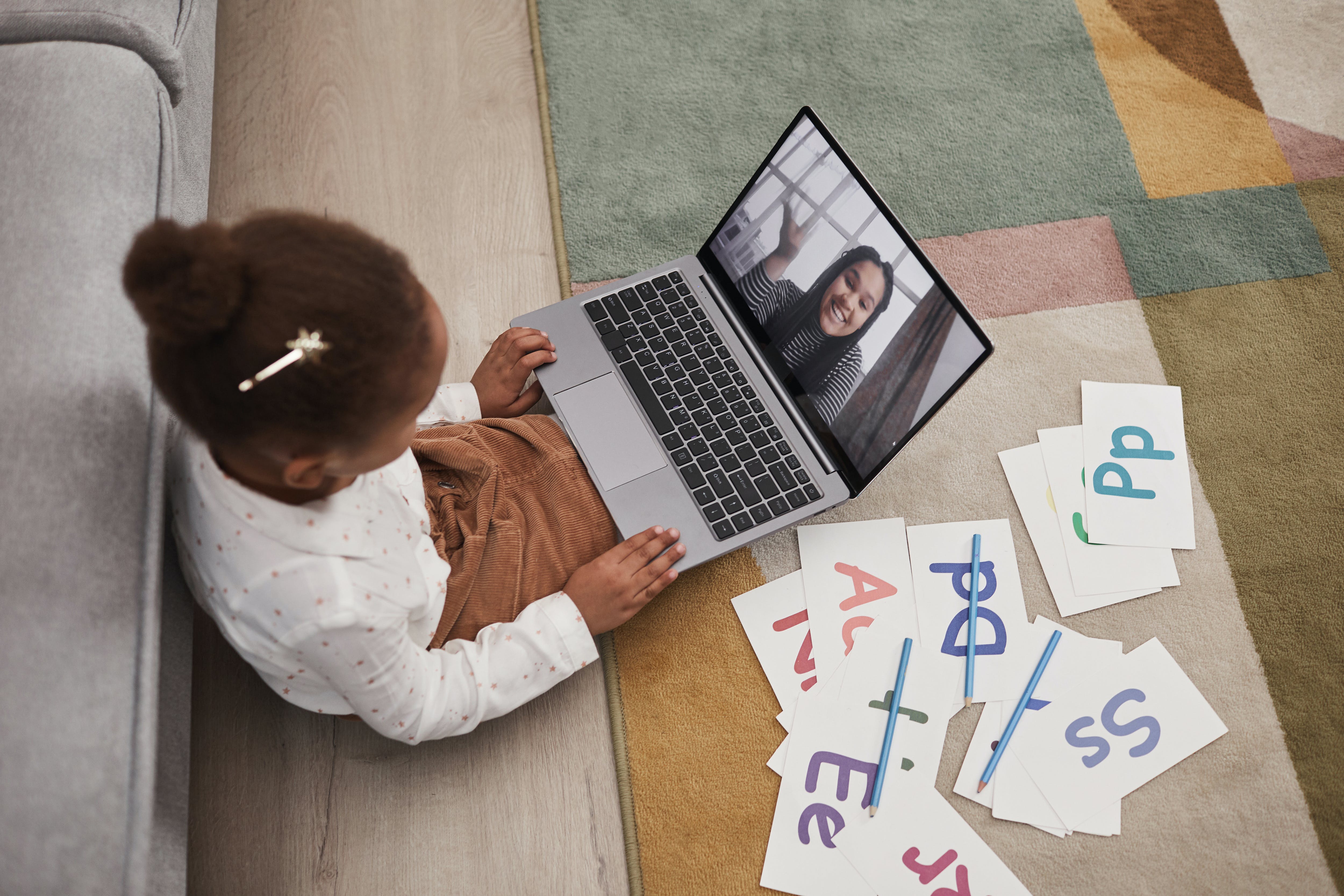 A student participates in remote learning with a teacher.