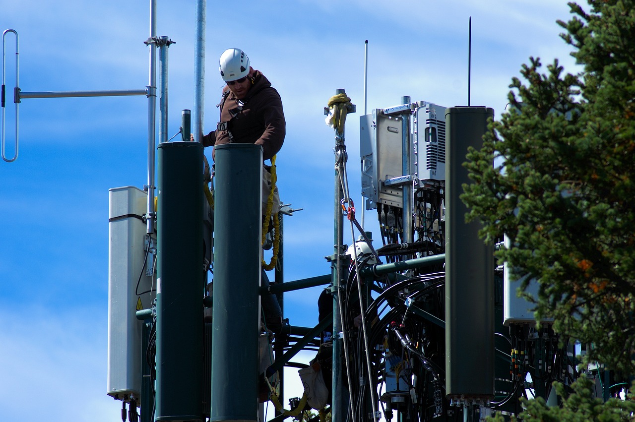 Worker operates on a cell tower.