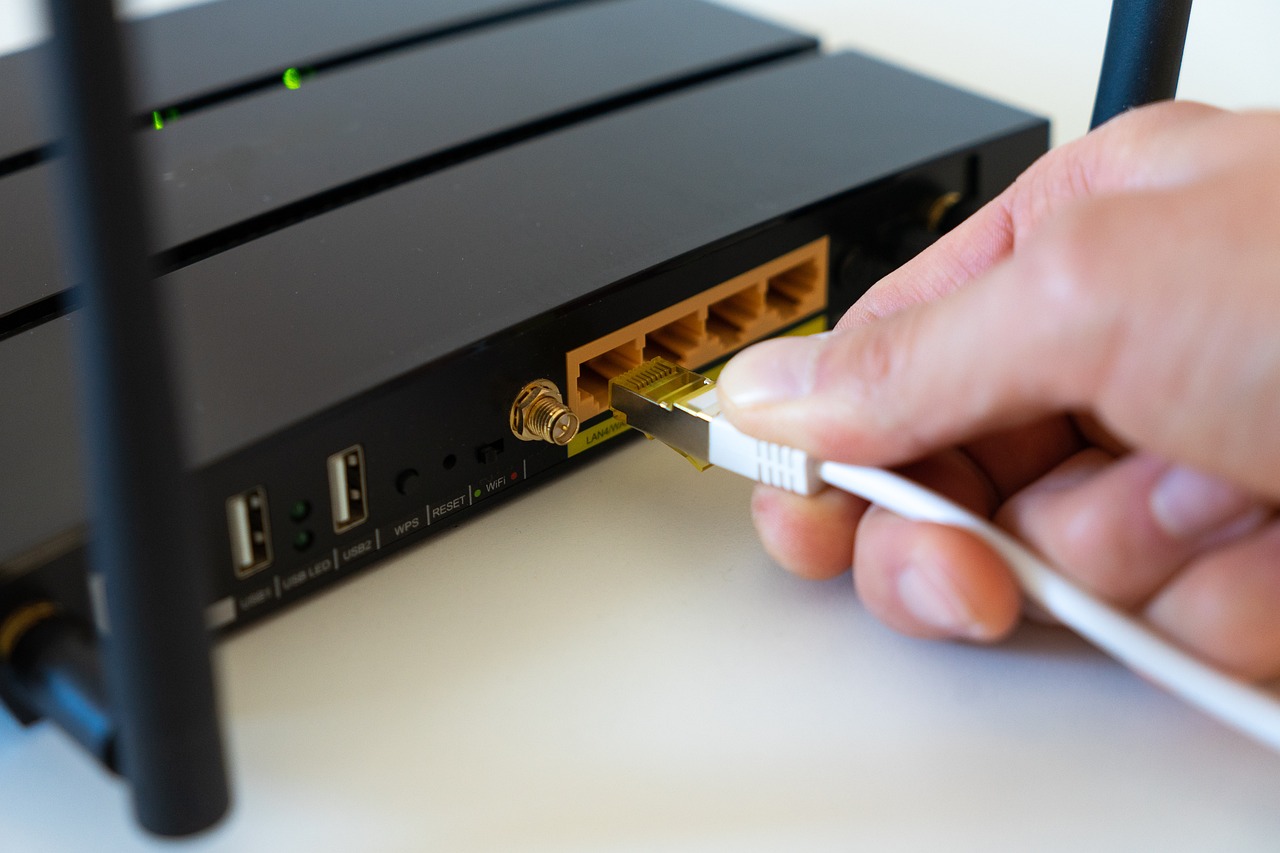 A cable being plugged into a modem.