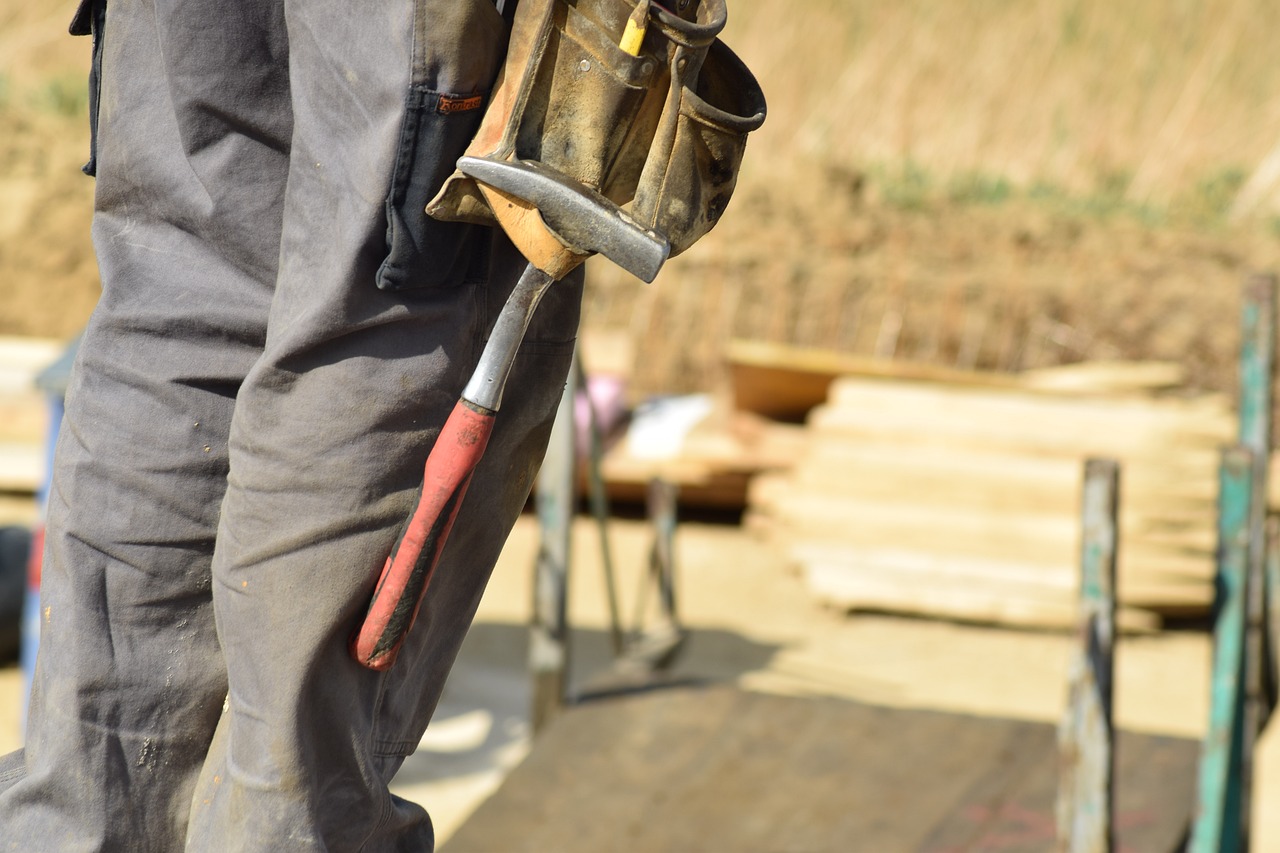 A construction worker wears a tool belt.