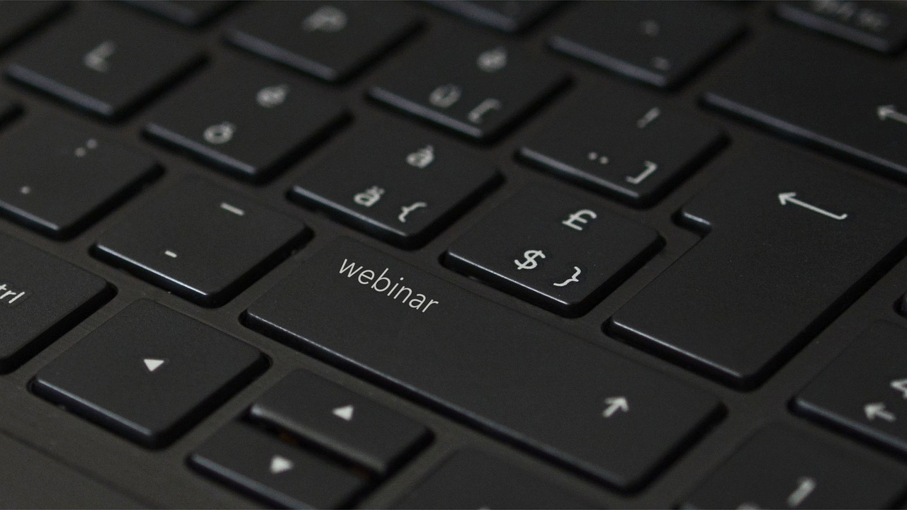 Webinar written on a keyboard.
