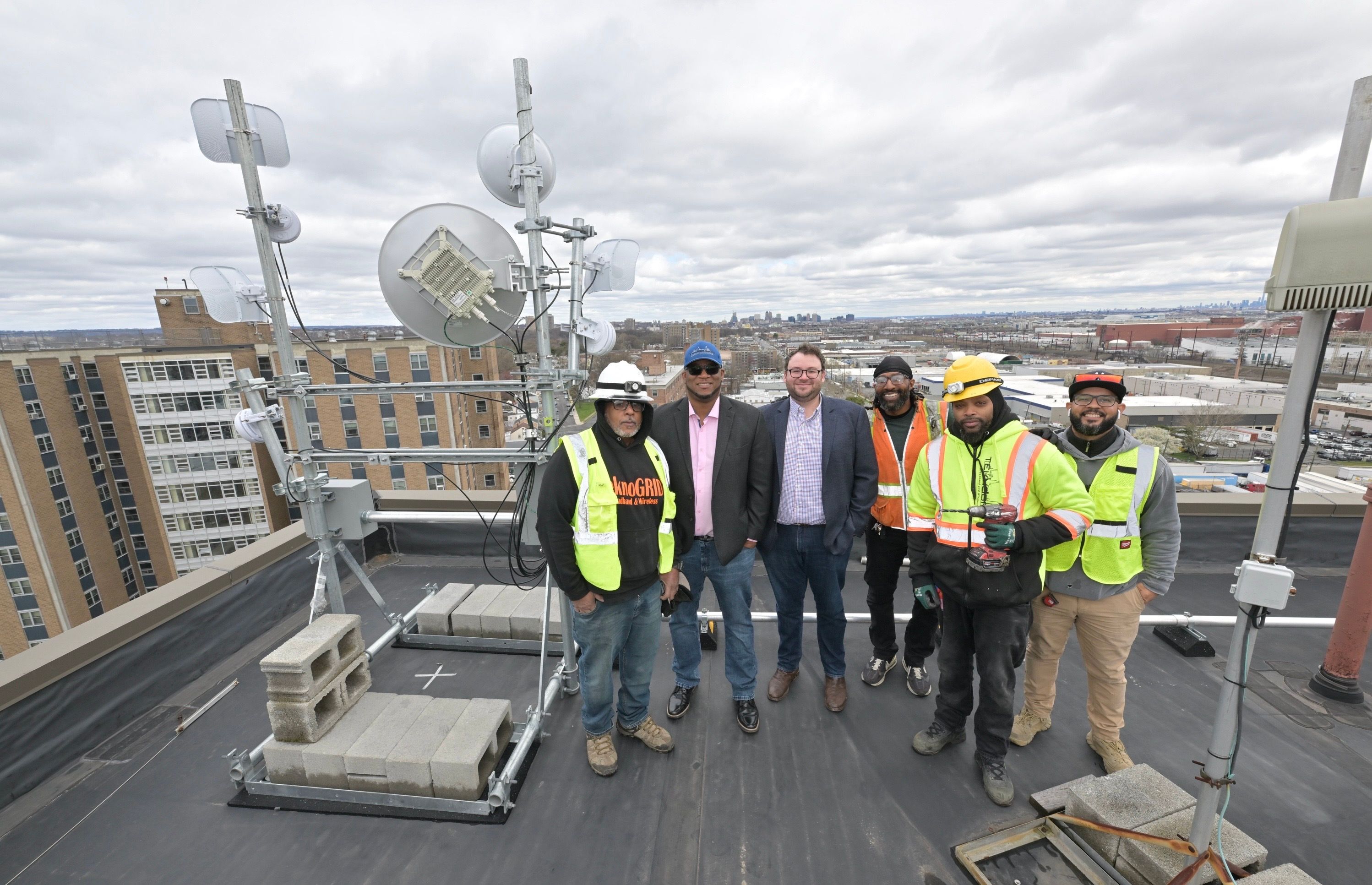Internet workers atop an MDU in Newark.