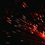 A close up of a red firework in the dark