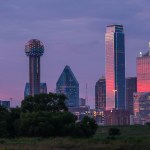 a view of a city skyline with a water tower in the foreground