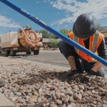 a photo of workers laying fiber cable in a neighborhood via the microtrenching method