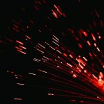 A close up of a red firework in the dark