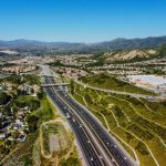 an aerial view of a highway in the mountains