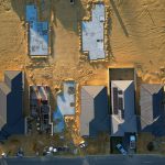 An aerial view of a construction site with blue shutters