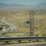a view of a road and mountains from inside a vehicle