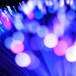 Blury lights illuminate fiber optic cables.