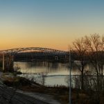 a bridge over a body of water at sunset
