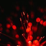 A close up of a red firework on a black background