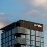 a very tall building with a verizon sign on top