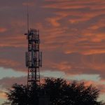 a tower with a cell phone on top of it