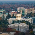 Stunning aerial view of the iconic California State Capitol in Sacramento surrounded by cityscape.
