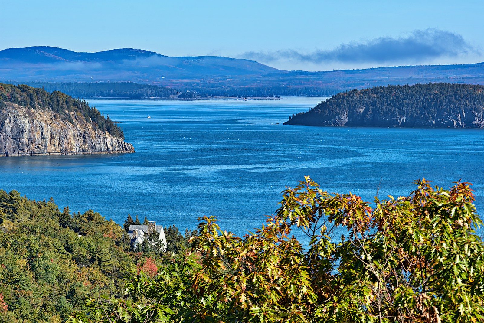 a scenic view of a lake surrounded by mountains