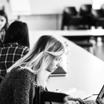 woman in black long sleeve shirt using laptop computer