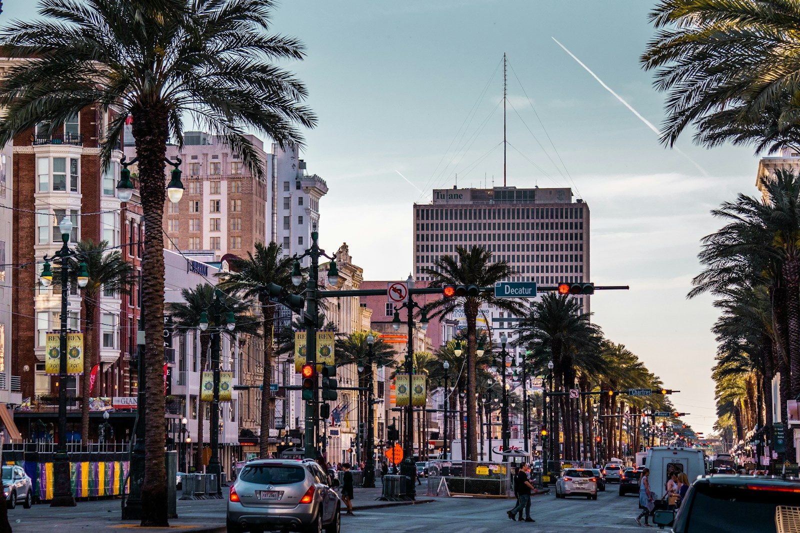 a city street with palm trees and traffic lights
