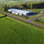 an aerial view of a farm and a road
