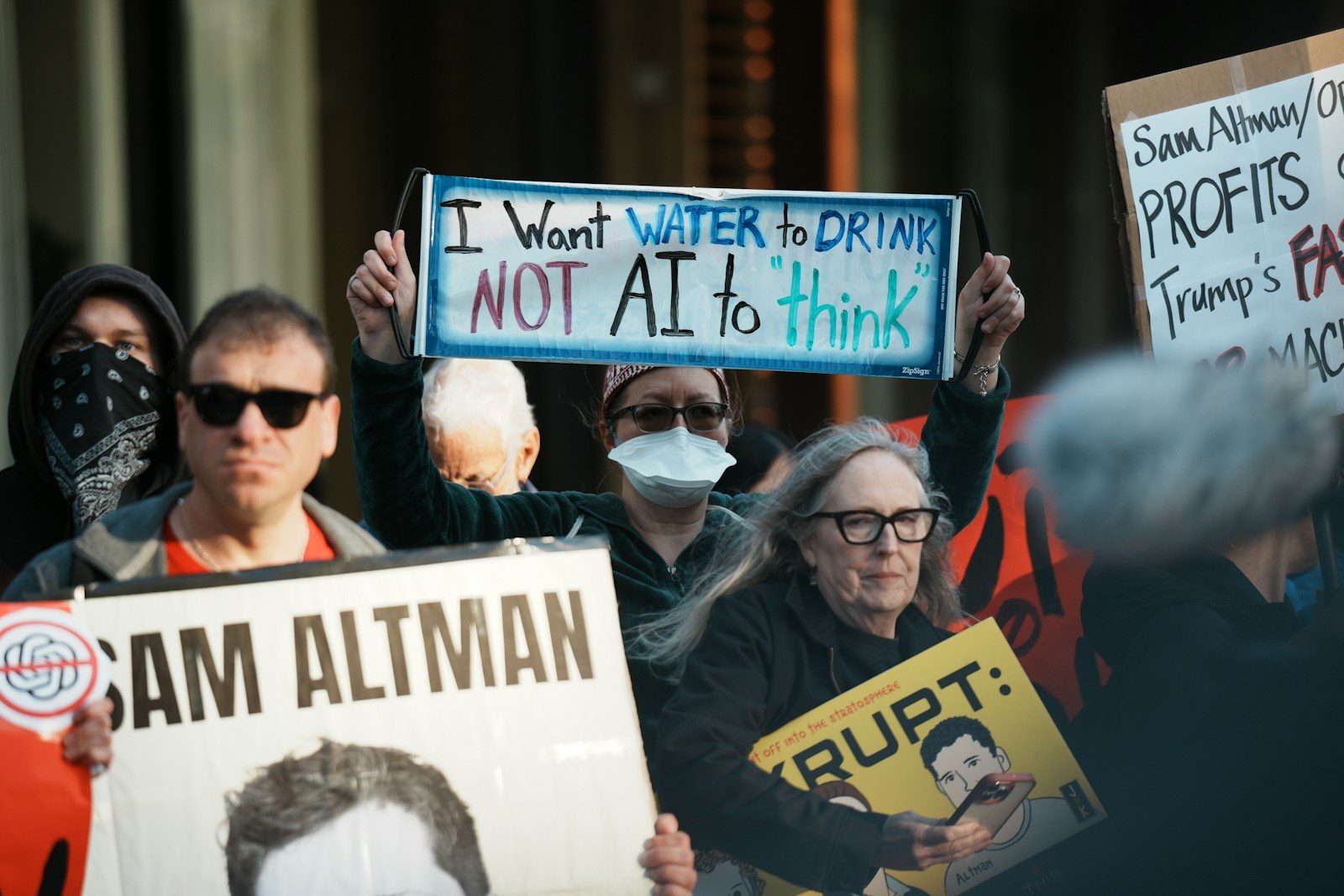 Protesters hold signs at a demonstration