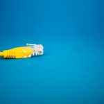 a yellow ethernet cable on a blue background