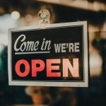 a sign that says come in we're open