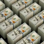 Stacks of hundred dollar bills are shown