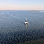 A sailboat in the middle of a large body of water